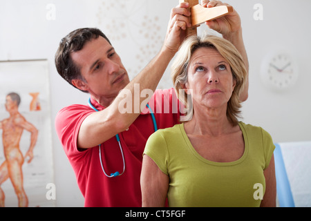 MEASURING HEIGHT, ELDERLY PERSON Stock Photo