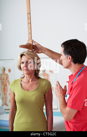 MEASURING HEIGHT, ELDERLY PERSON Stock Photo