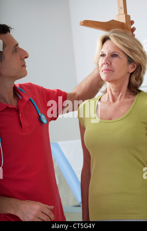 MEASURING HEIGHT, ELDERLY PERSON Stock Photo