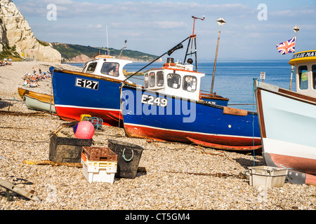 Blue fishing boats on the shingle beach at Sidmouth, Devon, England, UK Stock Photo
