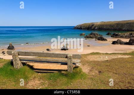 Bench overlooking beach of golden sands and turquoise sea on scenic north west coast Sango Bay Durness Sutherland Scotland UK Stock Photo