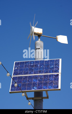 A small wind turbine and solar panel, Paignton, Devon. Renewable energy powers the hanging lights. Stock Photo