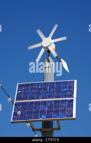 A small wind turbine and solar panel, Paignton, Devon. Renewable energy powers the hanging lights. Stock Photo