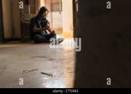 Heroin junkie shooting up drugs with syringe. Low angle view, copy space Stock Photo