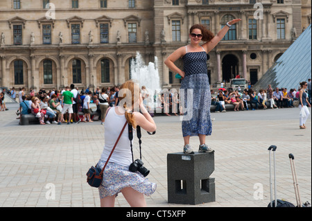 Paris, France - Two female tourists taking photos in the Louvre area. Stock Photo
