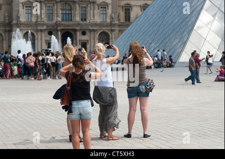 Paris, France - A group of female teens taking photos in the Louvre ares Stock Photo