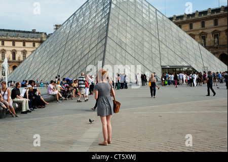 Paris, France - A young female tourist standing in front of the Louvre museum Stock Photo