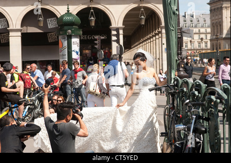 Paris, France - Bride posing for a photographer in the streets. Stock Photo