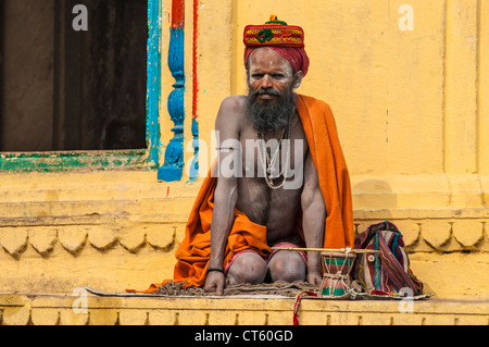 Indian Hindu meditates in front of a temple on the Ganges River, Varanasi, Uttar Pradesh, India Stock Photo