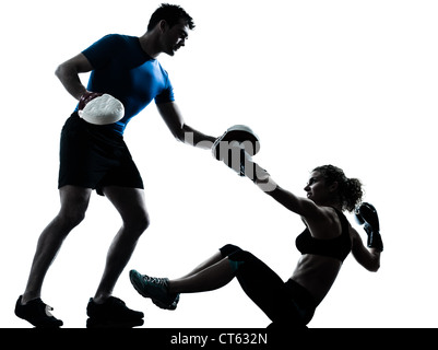 one caucasian couple man woman personal trainer coach man woman boxing training silhouette studio isolated on white background Stock Photo