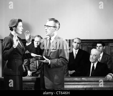 Woman taking oath in court Stock Photo