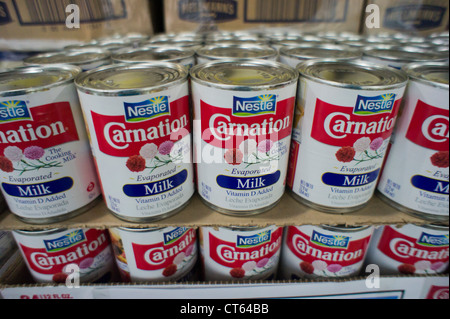 Cans of Nestle Foods product, Carnation Evaporated Milk, are seen on a supermarket shelf in New York Stock Photo