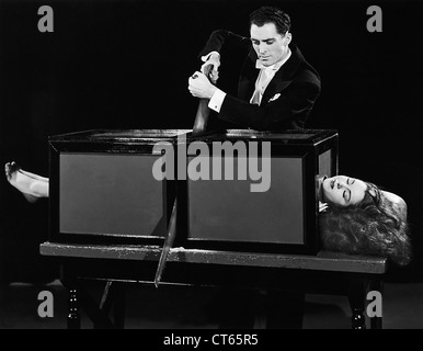 Magician sawing woman in half Stock Photo - Alamy