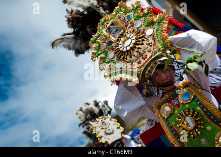 A young dancer (danzante) performs in the religious parade within the Corpus Christi festival in Pujilí, Ecuador. Stock Photo