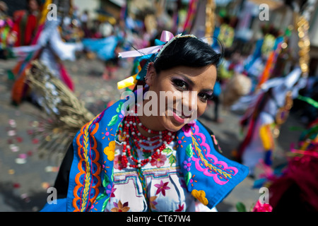A dancer (danzante) performs in the religious parade within the Corpus Christi festival in Pujilí, Ecuador. Stock Photo