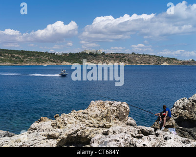 dh Cape greco National Park CAPE GREKO SOUTH CYPRUS Watersport speedboat and man fishing Konnos Bay Agioi Anargyroi people greece angler Stock Photo