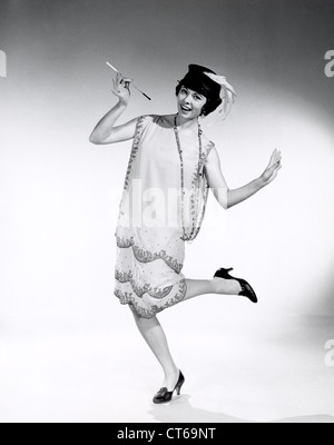 A portrait of a woman dressed in vintage 1920's flapper style clothing ...