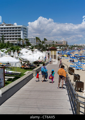 dh Fig Tree Bay PROTARAS CYPRUS Family on boardwalk promenade sandy beach coast Hotels holiday resort sunny sunshine beaches Stock Photo