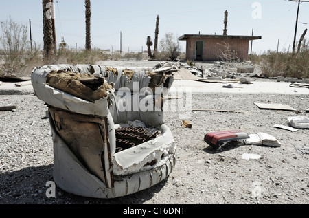 Abandoned upholstered chair on waste ground Salton Sea Beach, California, USA. Stock Photo