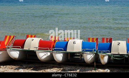 Colorful pedal boats on the beach Stock Photo