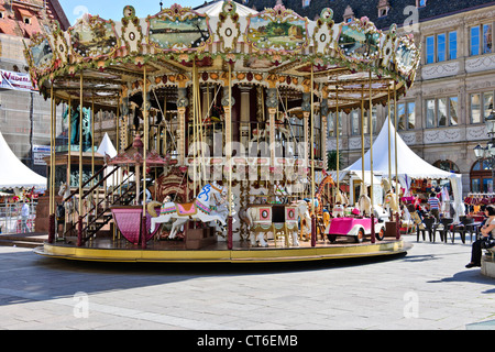 A carousel (from French carrousel, from Italian carosello),or merry-go-round,Place Gutenberg,Strasbourg,Francee Stock Photo
