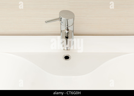 Modern tap with white ceramic sink. Stock Photo