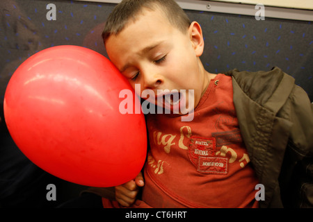 5-year-old boy falling asleep in public transport Stock Photo