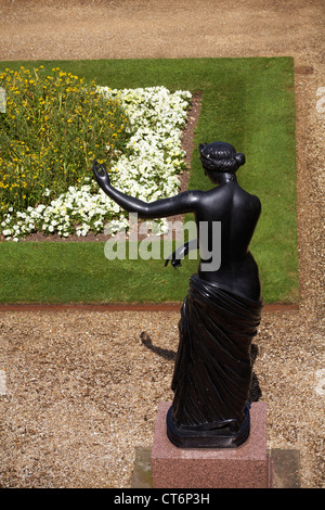 statue by flower bed in the gardens of Osborne House at East Cowes, Isle of Wight, Hampshire UK in June - Osbourne House Stock Photo