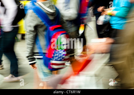Motion blur of a crowd of people moving on a busy city centre street Stock Photo