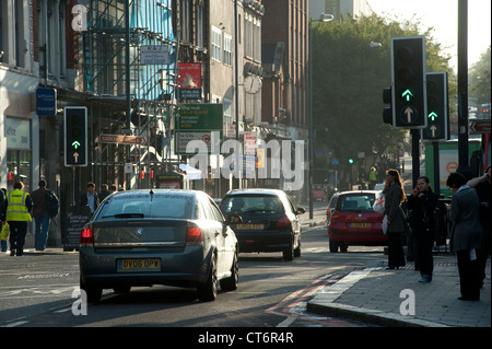 Traffic traveling along a busy London street early in the morning, England. Stock Photo