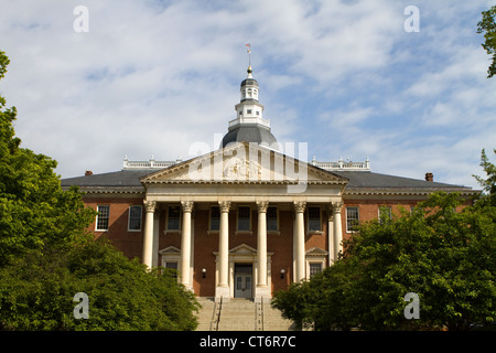 Maryland State Capitol building with dome against a cloudy blue sky with surrounding trees in Annapolis, Maryland, USA. Stock Photo