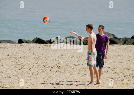 Boys playing volleyball on the beach Stock Photo