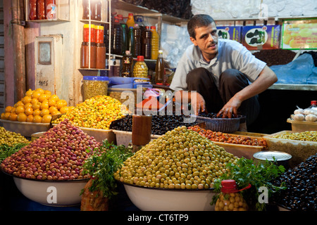 A an selling olives in the market souk, the Medina, Taroudant, morocco Africa Stock Photo