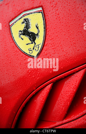 Crest on side of red Ferrari sportscar. Stock Photo