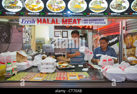 Los Angeles, California - Workers prepare take-out meals at a food stand that sells halal meat in Los Angeles' fashion district. Stock Photo
