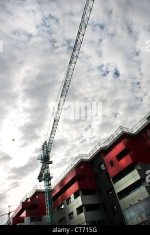 a crane over the buildings under construction Stock Photo
