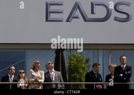 Guests admire aerobatic flying displays outside the EADS hospitality chalet at the Farnborough Air Show Stock Photo