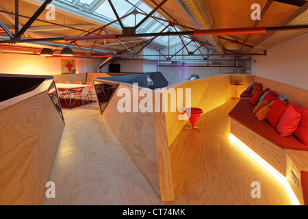 Red Bull Nederland Headquarters, Amsterdam, Netherlands. Architect: Sid Lee Architecture, 2011. Twin arms of mezzanine, with mee Stock Photo