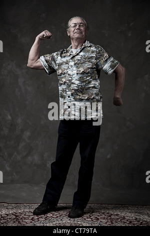 Portrait of a senior man flexing muscles Stock Photo