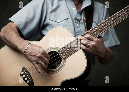 Man playing acoustic bass guitar Stock Photo