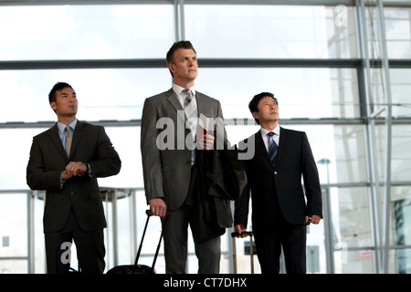 Businessmen arriving at airport Stock Photo