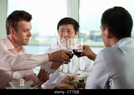 Multi racial businessmen toasting with wine