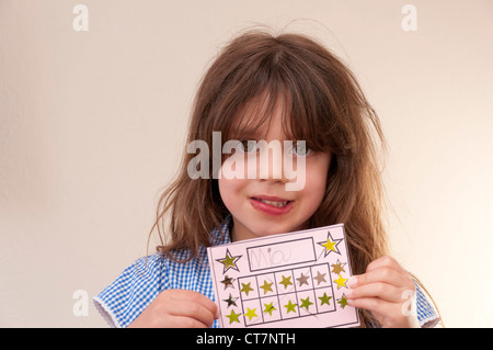 Child with completed sticker reward chart Stock Photo - Alamy