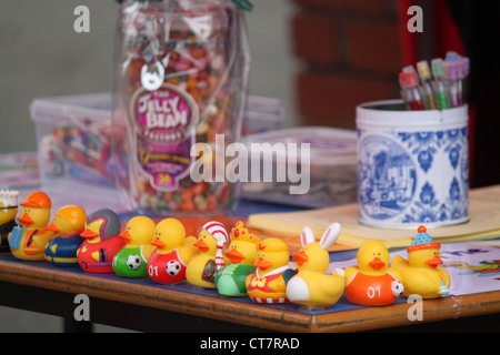 Hunt the rubber duck stand at a school fair with jelly beans and pencils in background Stock Photo