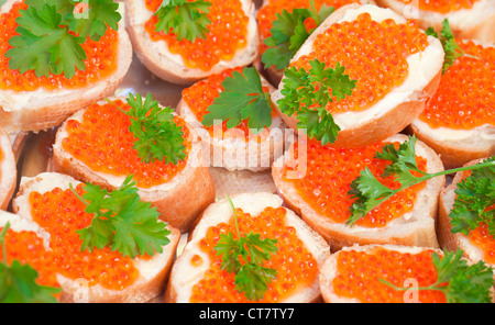 Russian appetizer background. Red caviar sandwiches Stock Photo