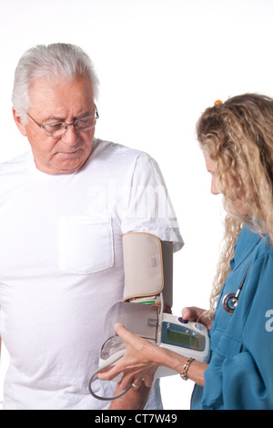 nurse takes blood pressure from senior patient Stock Photo