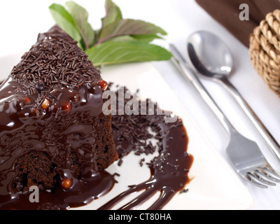 Chocolate cake served with mint leaves. Stock Photo