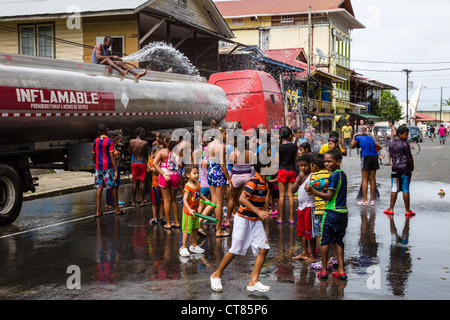 Panamanian Carnival tradition of the 'mojaderas' or 'getting drenched' with water on Isla Colon, Bocas del Toro, Panama. Stock Photo