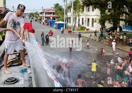 Panamanian Carnival tradition of the 'mojaderas' or 'getting drenched' with water on Isla Colon, Bocas del Toro, Panama. Stock Photo