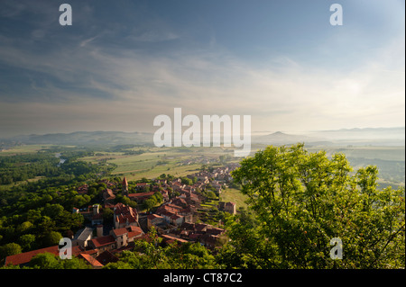 Misty dawn looking northwards over Nonette village towards the hillside village of Usson, from Pic de Nonette, Auvergne, France Stock Photo